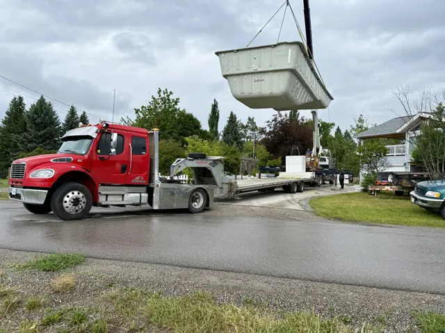 Pool being lifted by crane onto trailer